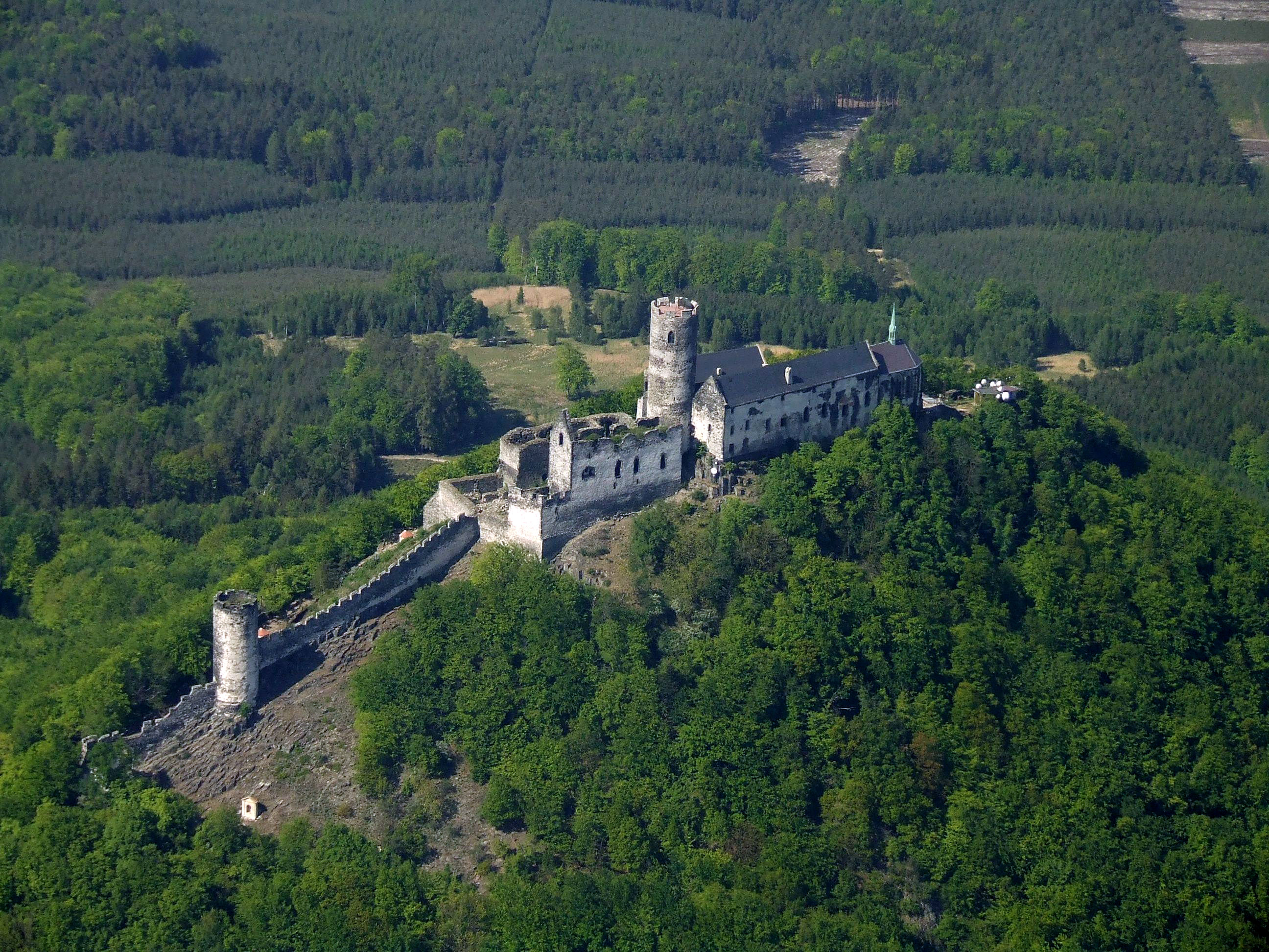Aerial view of Bezdez Castle ruins on forested hilltop